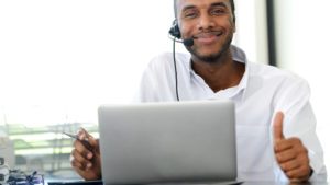 man with laptop and headset, working from home